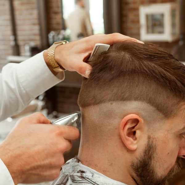A skin fade with a razor-sharp part, side view